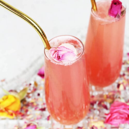 pink lemonade garnished with dried roses and a gold straw.
