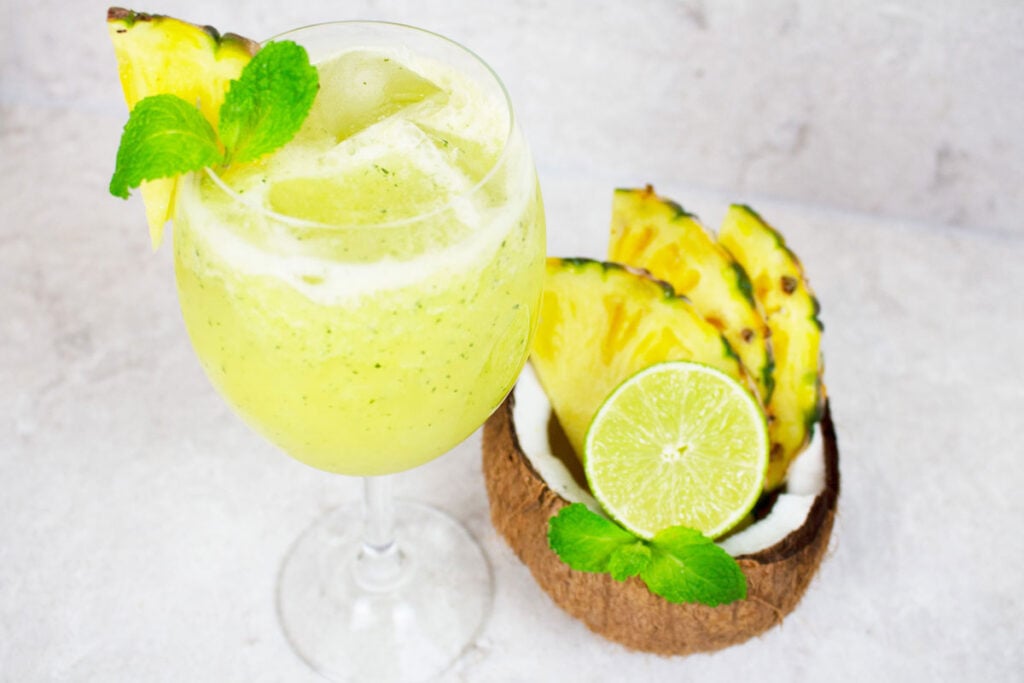 pineapple mocktail garnished with mint and fresh pineapple