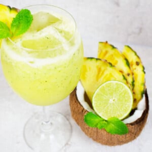 pineapple mocktail garnished with mint and fresh pineapple