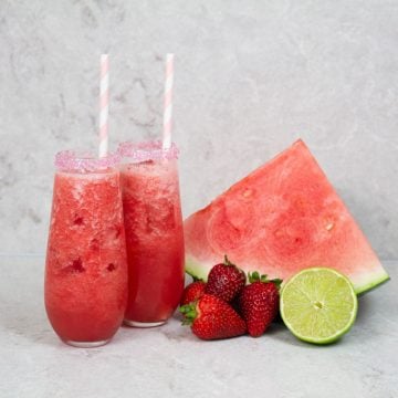 2 strawberry mocktails with pink and white striped straws