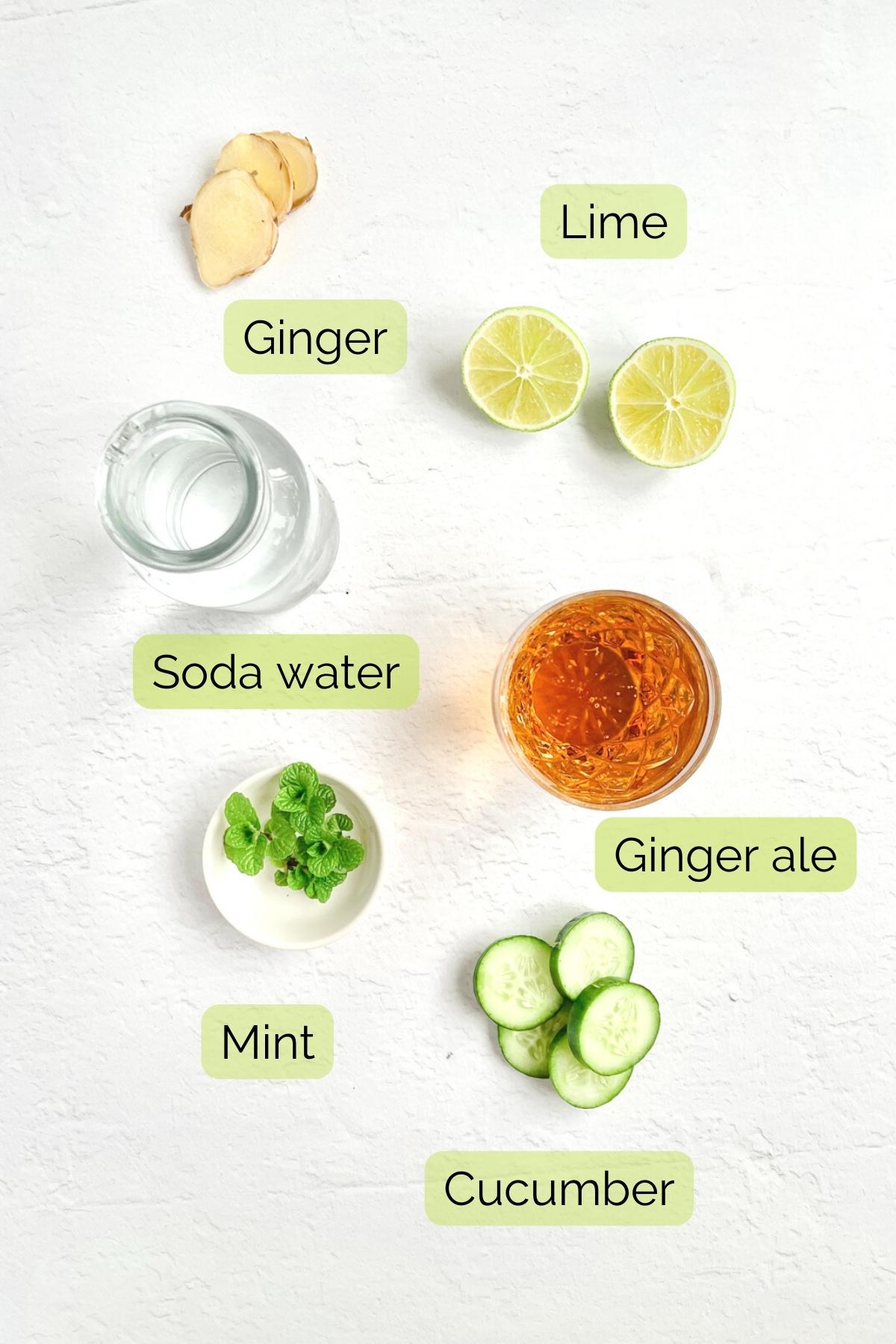 ginger mocktail ingredients including soda water, ginger ale, mint, lime, cucumber and fresh ginger