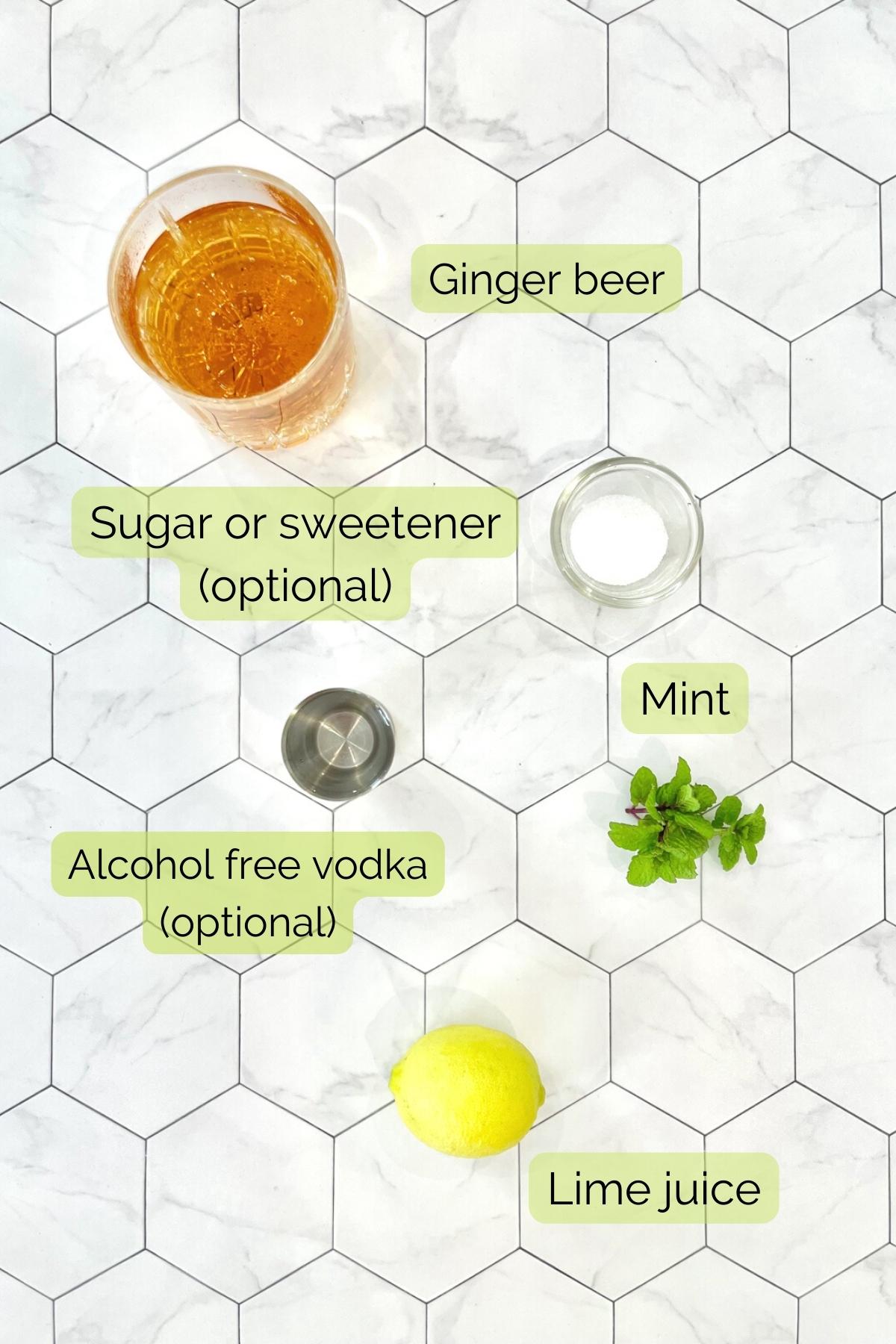 image of all recipe ingredients including ginger beer, sugar or sweetener, virgin vodka, mint and lime.