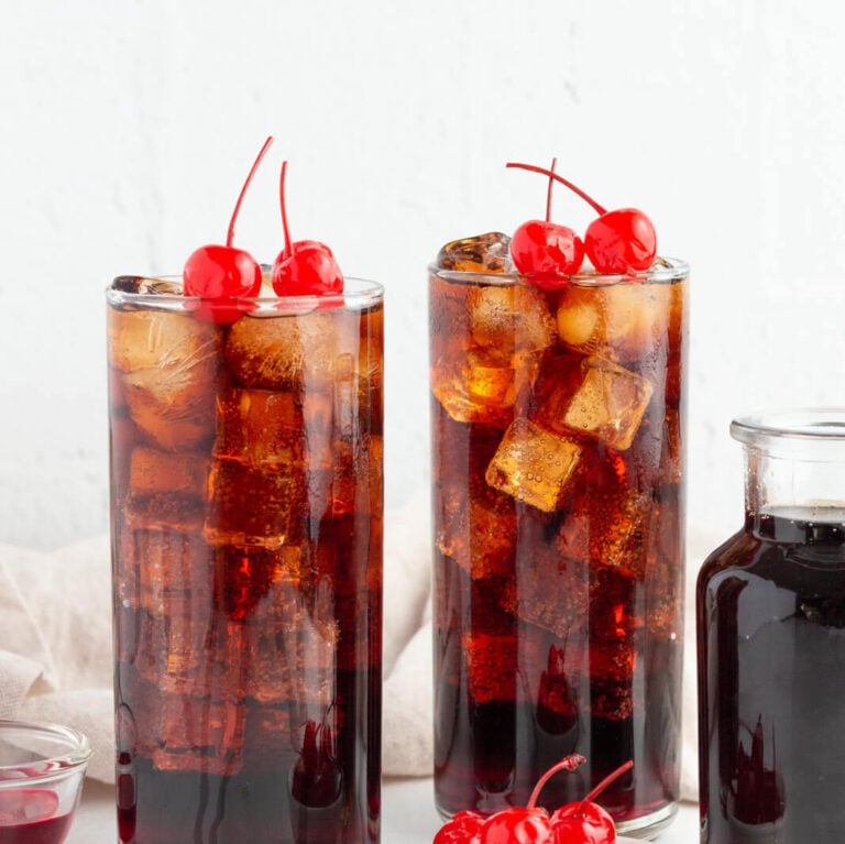 2 roy rogers mocktails garnished with maraschino cherries