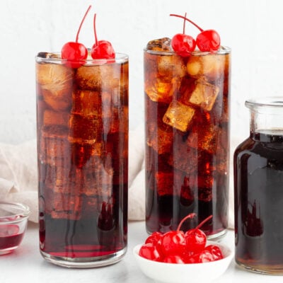 2 roy rogers mocktails garnished with maraschino cherries