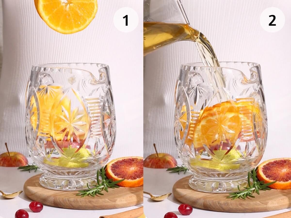 process shots for non alcoholic thanksgiving punch showing sliced orange being dropped into an intricate crystal pitcher on a wooden board scattered with rosemary and blood orange.