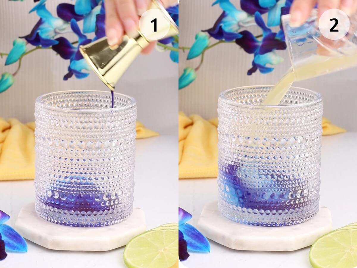 In a two-step process, a hand pours vibrant purple liquid from a small gold jigger into a textured glass, followed by pale yellow liquid from a clear cup. Nearby, lime slices and blue flowers evoke the tropical essence of a Blue Hawaii mocktail.