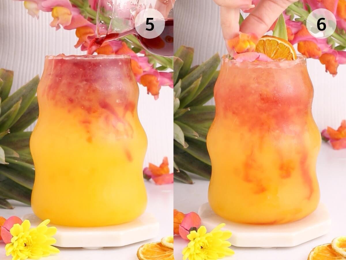 Two-panel image showing a wavy glass with orange and red layered drink. In the left panel, red liquid is being poured over yellow-orange juice. In the right panel, a hand places a dried orange slice on top. Pink flowers decorate the scene.