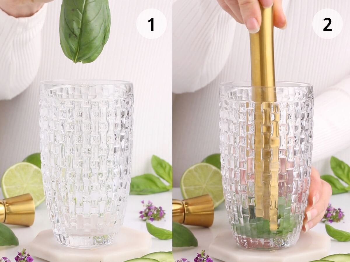 Side-by-side images: 1) A hand places basil leaves into a textured glass. 2) The hand uses a gold muddler to press the basil in the glass. Lime slices and purple flowers are nearby.
