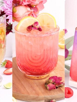 Three colorful, floral-mocktails drinks in decorative glasses, garnished with flowers, lemon slices, and fruit, displayed against a light background with scattered flowers and fruit for a bright, fresh presentation.