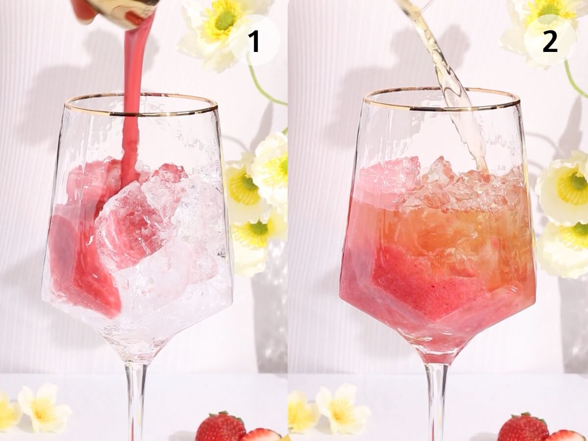 Two-panel image: (1) Pink liquid being poured over ice in a wine glass. (2) Clear liquid added to the same glass with pink mixture. Yellow flowers and strawberries are in the background.