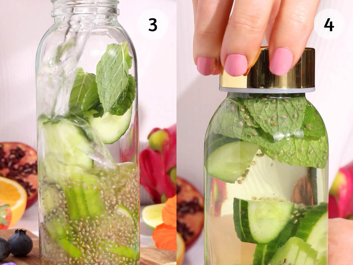A hand with pink nail polish closes a glass bottle filled with water, cucumber slices, mint leaves, and chia seeds. The bottle is surrounded by various colorful fruits and flowers.